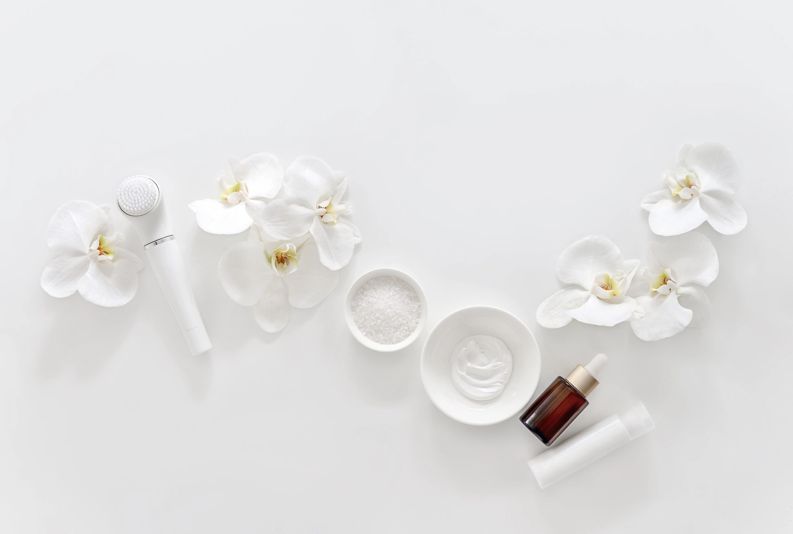 Spa background with skincare tools and cosmetic products, flat lay