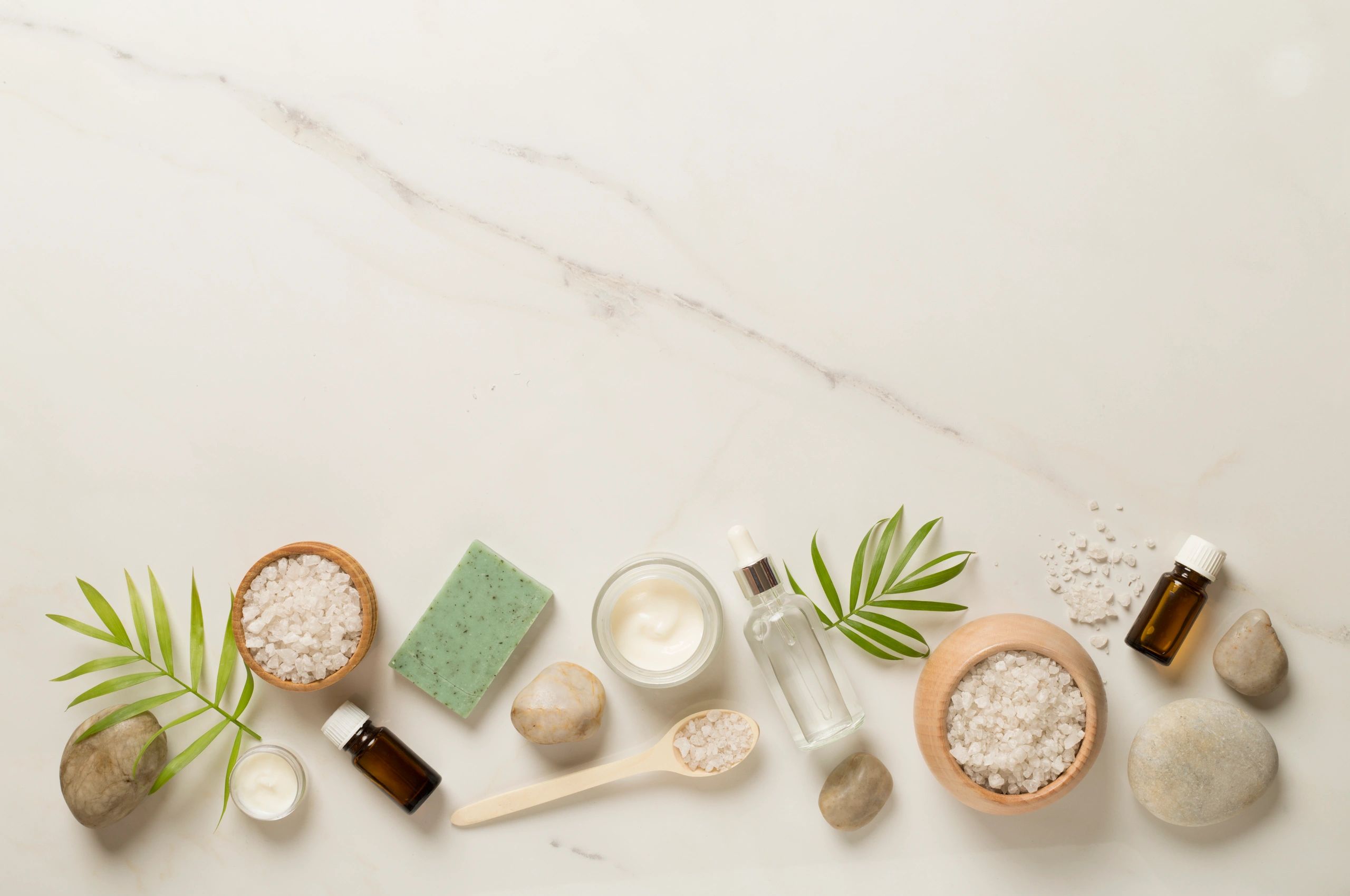 Spa products on marble background, flat lay