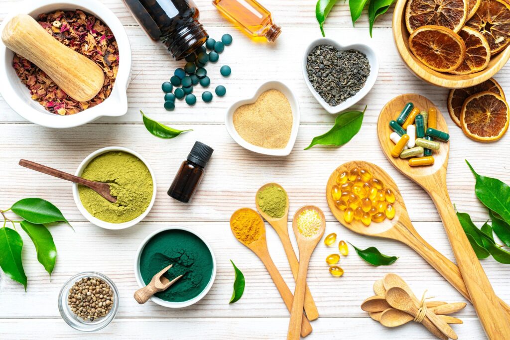 White table filled with nutritional supplements and natural vitamins. Healthy eating and dieting, healthcare or alternative medicine. Spirulina pills, Moringa powder and Omega-3 capsules, Magnesium and Calcium