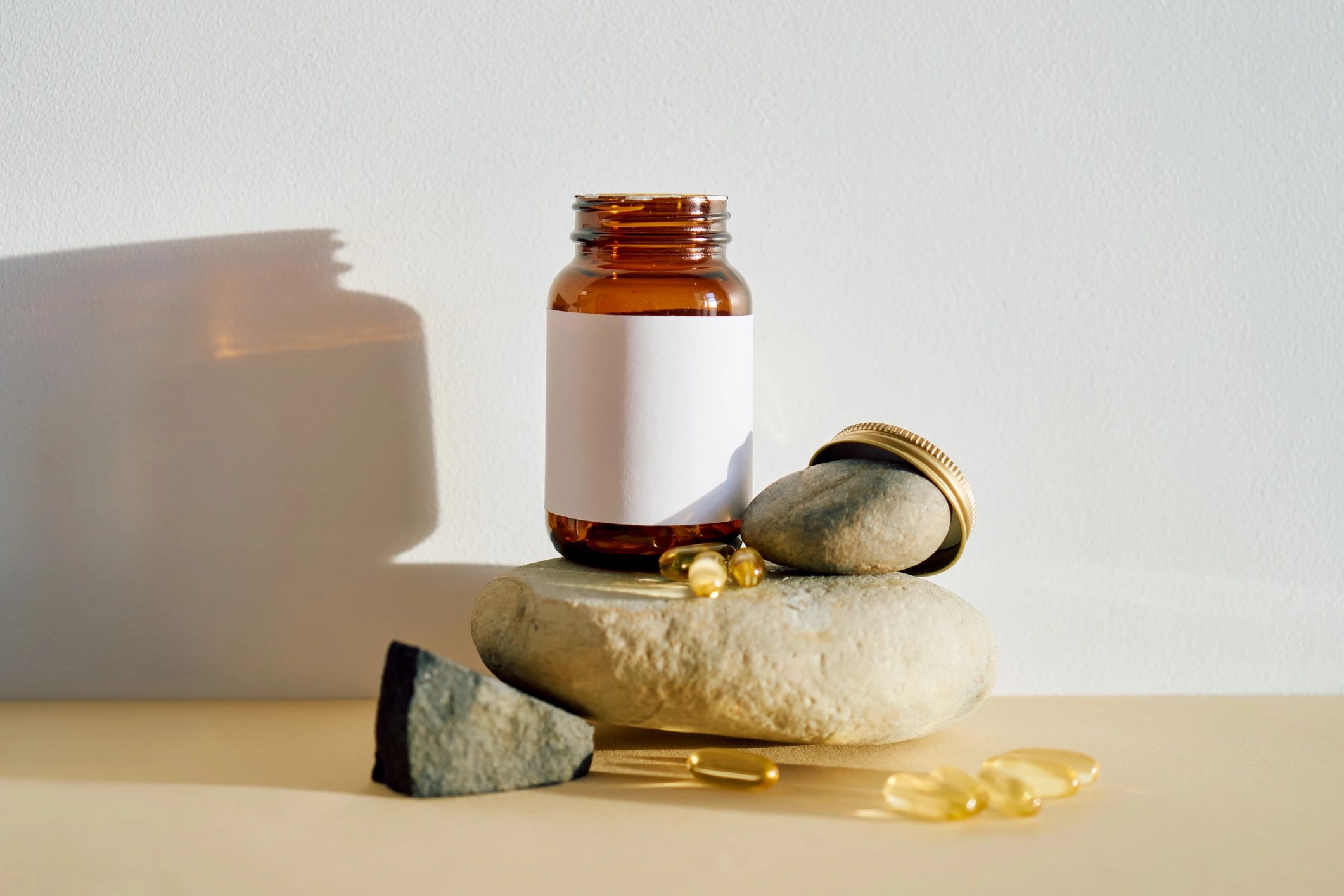 Amber glass bottle mockup with supplement capsules